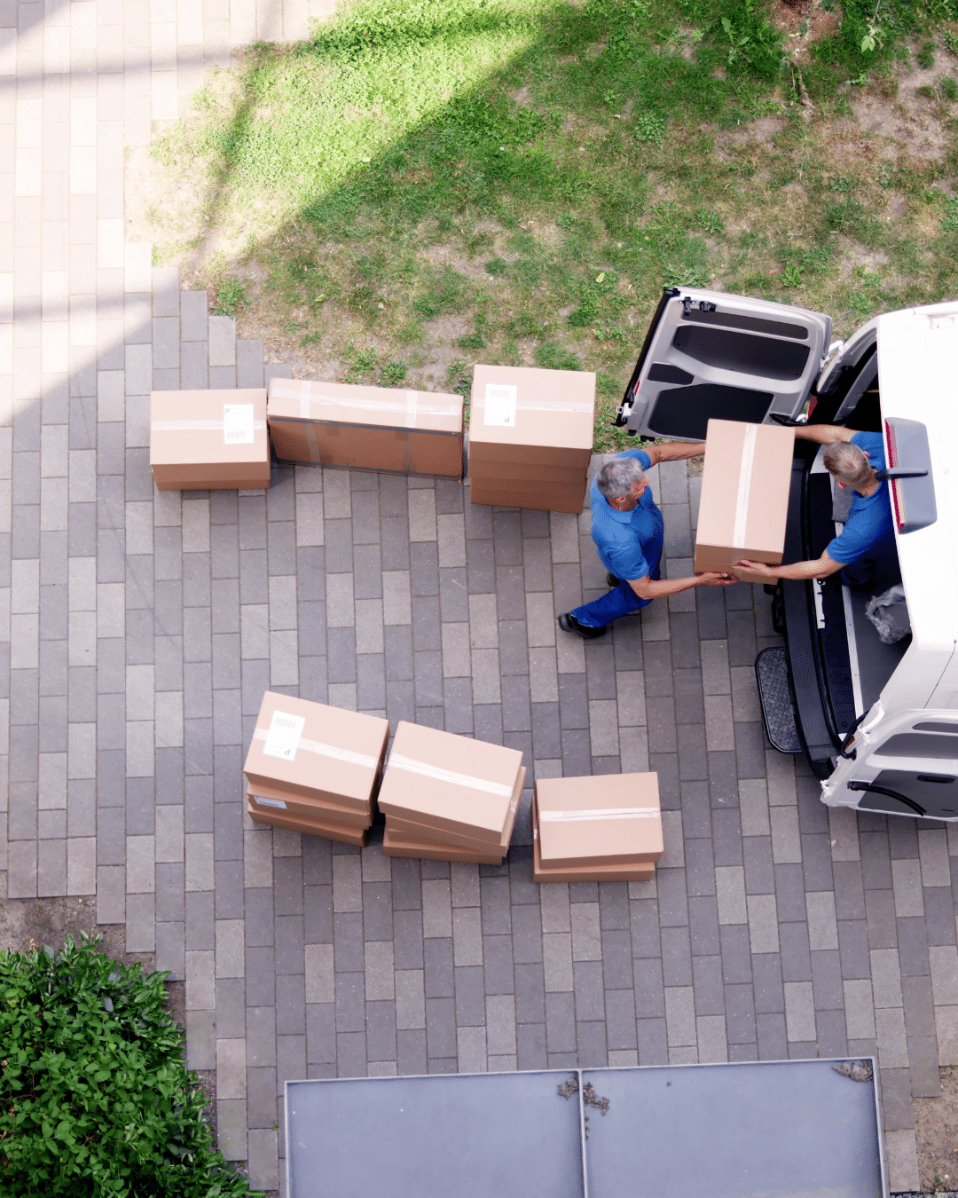 Long-distance movers loading household items into a moving truck in Greenville, NC